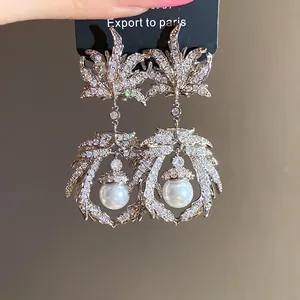 Vintage silver needle drop earrings with zircon maple leaf and pearl detail