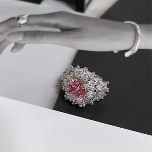 Detailed view of a luxury pink square zircon flower ring with sparkling white accents