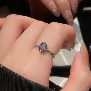 Close-up of a vintage silver open ring with a stunning rectangular purple gemstone