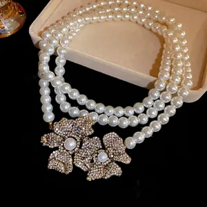 Elegant vintage multi-strand pearl necklace with luxury rhinestone flower pendant
