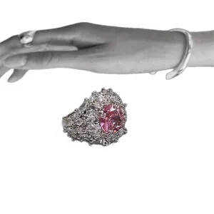 Elegant silver ring with a large pink zircon center stone and sparkling diamond accents