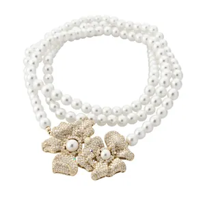 Elegant vintage multi-strand white pearl necklace with crystal-encrusted floral pendant