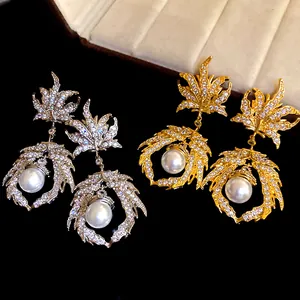 Detailed view of luxury maple leaf drop earrings with zircons and pearls