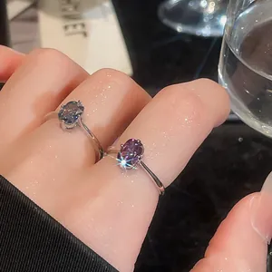 Close-up of vintage minimalist silver open rings with oval blue and purple gemstones