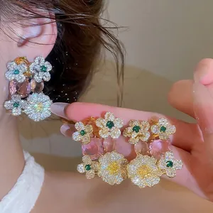 Sparkling zircon flower earrings with pink oval crystals and emerald green accents