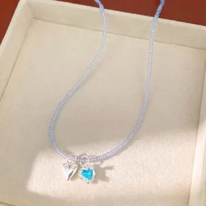 Handmade blue beaded necklace featuring a silver heart and sparkling blue zircon pendant