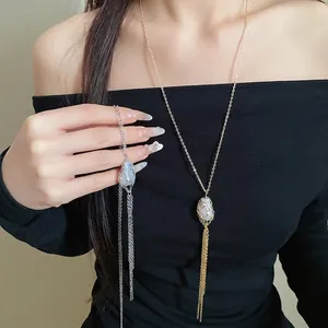 Elegant retro tassel necklace with iridescent stone and long metal chains in gold and silver