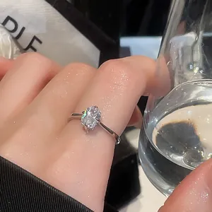 Close-up of a vintage silver ring with a large oval crystal on a woman's finger.