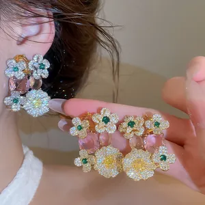 Detailed view of high-end sweet resort style flower earrings with pink oval pendants.