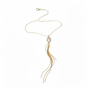 Vintage gold tassel necklace with crystal pendant featuring an interlocking metal design