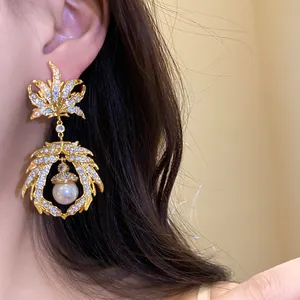 Detailed close-up view of vintage golden zircon maple leaf drop earring with elegant pearl