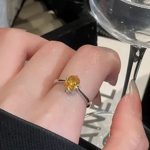Detail view of a vintage minimalist ring featuring a stunning yellow oval gemstone.