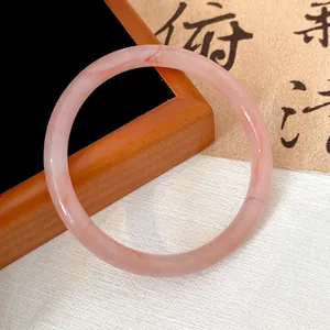 Close-up of translucent dried rose pink glass bangle with elegant marbled pattern