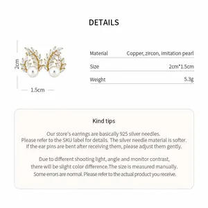 Detail view of 18k gold plated wheat pearl earrings with size and material specs.
