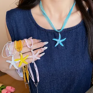 Close-up of colorful resin starfish necklaces with glitter texture and cord chain