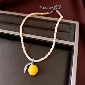 Elegant vintage resin lemon pendant necklace featuring sparkling zircon encrusted leaf