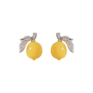 Elegant lemon stud earrings crafted with yellow resin and sparkling zircon leaf details
