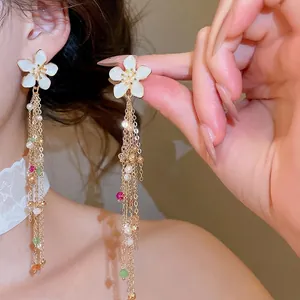Elegant white drip oil flower tassel earrings with pearls for a sweet vacation look
