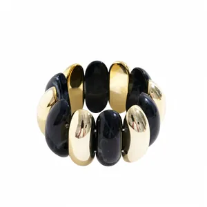 Chunky geometric acrylic bracelet featuring gold and marbled black alternating segments.