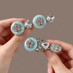 Close-up detail of luxury light blue rhinestone flower and bow duckbill hair clips