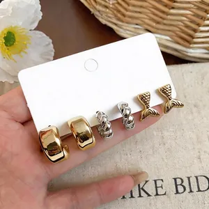 Elegant set of assorted fish tail and twisted C-shaped hoop earrings in gold and silver