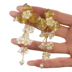 Elegant French style gold flower tassel earrings with white pearls and petals for women.