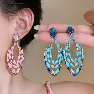 Detail view of light luxury hollow earrings with rhinestones and colorful drip oil finish