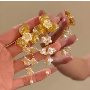 Detailed view of French vintage floral tassel earrings with gold and pearl accents