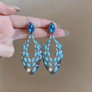 Exaggerated light luxury stud earrings with blue rhinestones and hollowed-out design