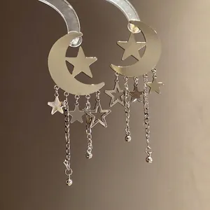 Elegant silver moon and star tassel earrings with celestial design charms for women