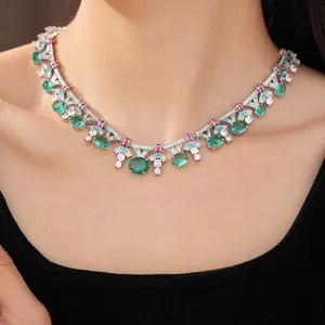 Detailed close-up of a vintage palace style necklace featuring green oval zircons and enamel