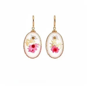 Elegant resin oval drop earrings featuring real dried flowers and luxury gold foil flakes
