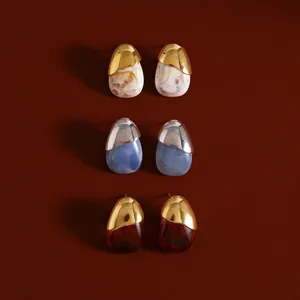 Detail view of water drop resin stud earrings in various colors and metallic finishes