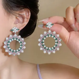 Detail view of vintage oversized earrings with pink zircons and white pearls