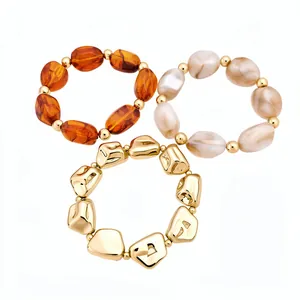 Set of three irregular geometric acrylic and metallic elastic bracelets in retro style