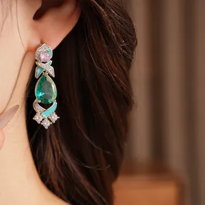 Close-up of luxury palace style dripping oil zircon drop earring worn by a model
