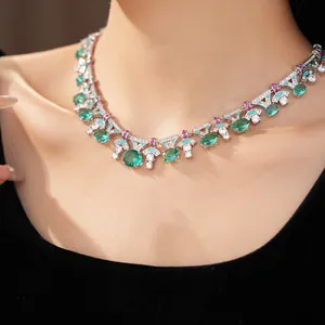 Elegant close-up of palace style necklace with oval green zircons worn on model neck
