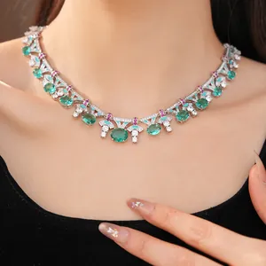 Detailed close-up of palace style enamel necklace with green oval stones on neck