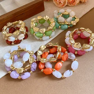 Colorful acrylic elastic bracelets with geometric gold-tone accents in various retro styles.