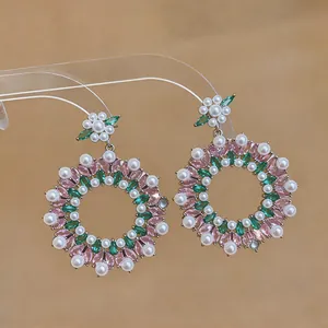 Detailed view of vintage-inspired hoop earrings featuring pink green zircon and pearls