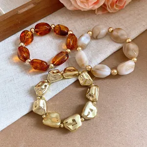 Detailed view of three irregular geometric acrylic elastic bracelets in vintage style