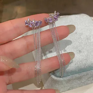 Detailed macro view of purple star ear clips featuring ultra-long silver-tone tassel chains
