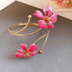 Elegant gold-tone arm cuff jewelry featuring vibrant pink enamel floral blossoms for women