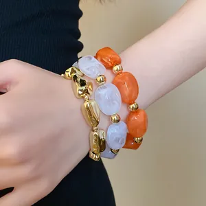 Detailed view of vintage irregular geometric acrylic elastic bracelets set worn on a wrist