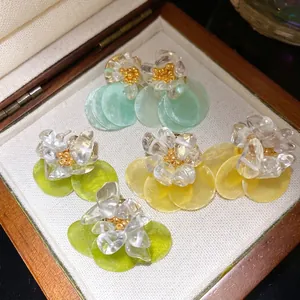 Handmade floral stud earrings with clear stones and shell discs in summer colors