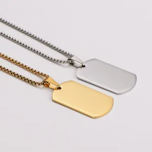 Detailed macro view of gold and silver mirror finish stainless steel dog tag necklaces.
