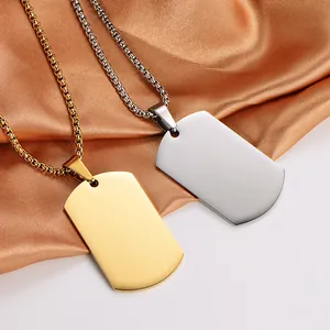Detail view of gold and silver stainless steel dog tag pendants on silk fabric