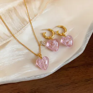Romantic pink glass heart earrings and necklace set with delicate gold bead chain.
