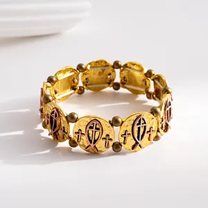 Close-up of vintage gold and bronze bracelet with religious cross and fish motifs