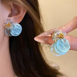 Detailed view of elegant shell flower stud earrings with summer vacation vibes.
